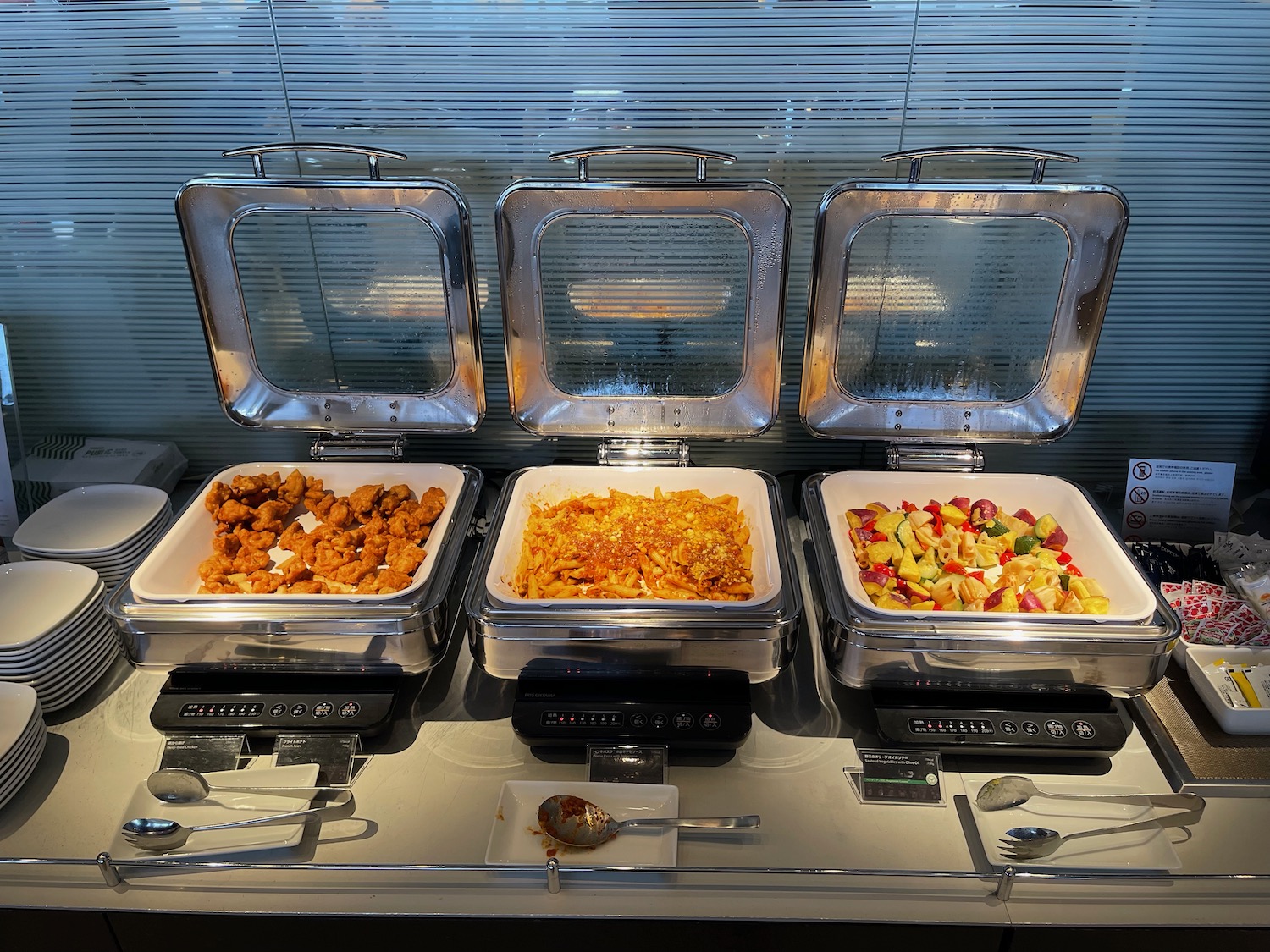 food in a buffet with a row of food in containers