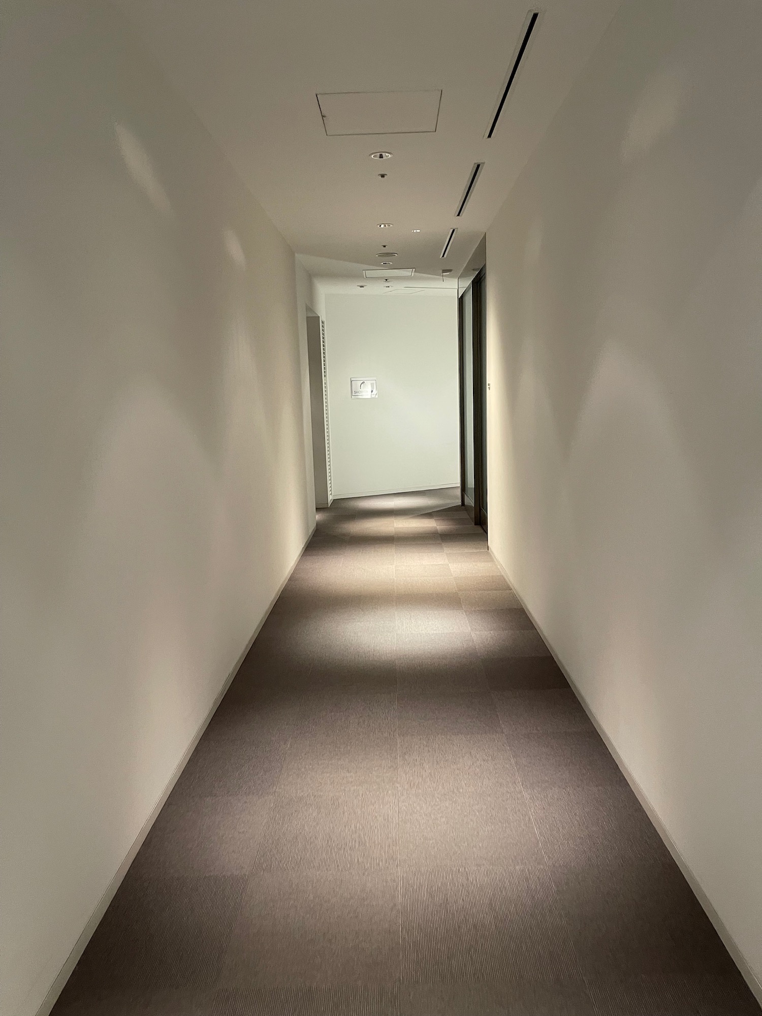 a hallway with a light on the wall