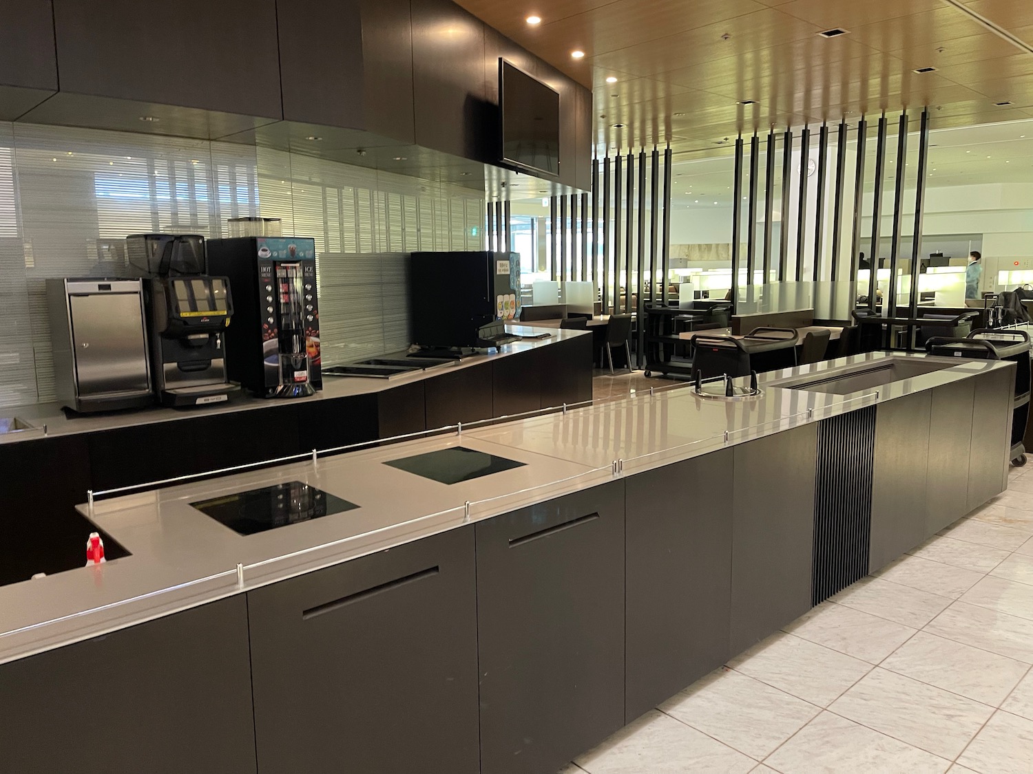 a kitchen with black cabinets and a white tile floor
