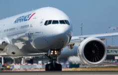 a large white airplane on a runway