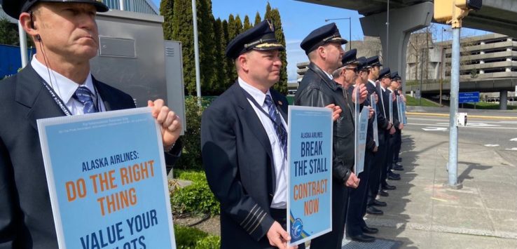 a group of men in uniform holding signs