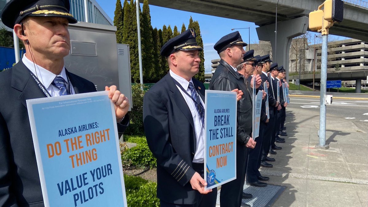 a group of men in uniform holding signs