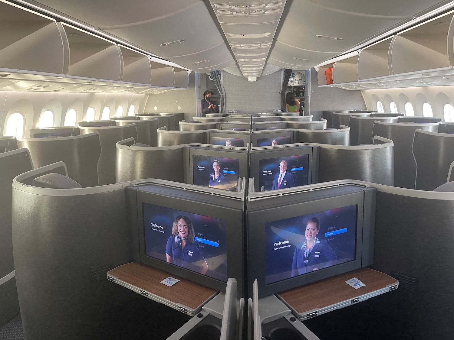 a row of seats with monitors on the side