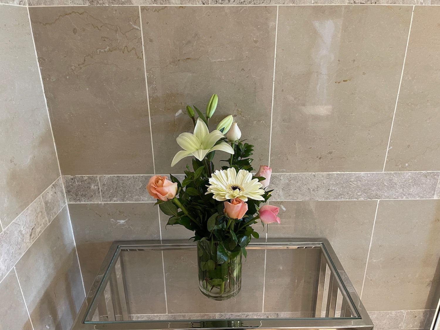 a vase of flowers on a glass table