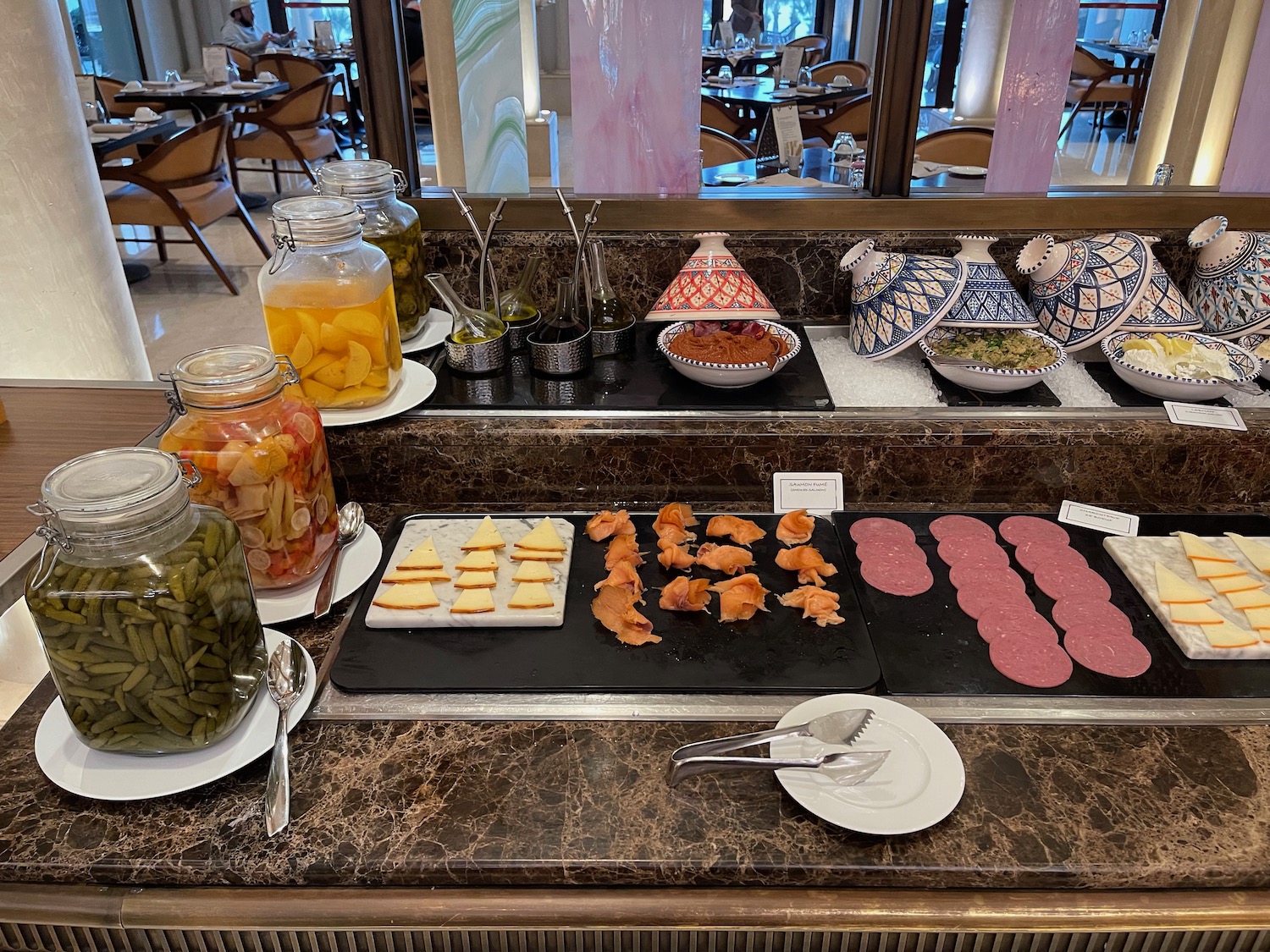 food on a counter with jars of food