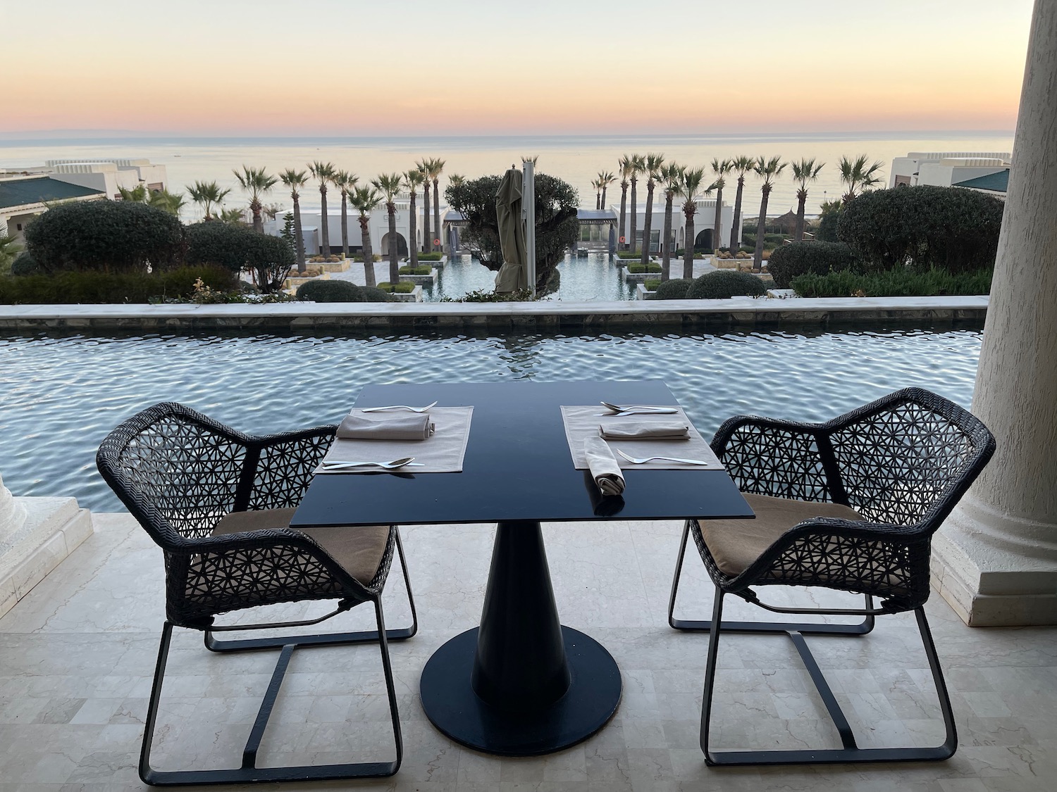 a table and chairs by a pool