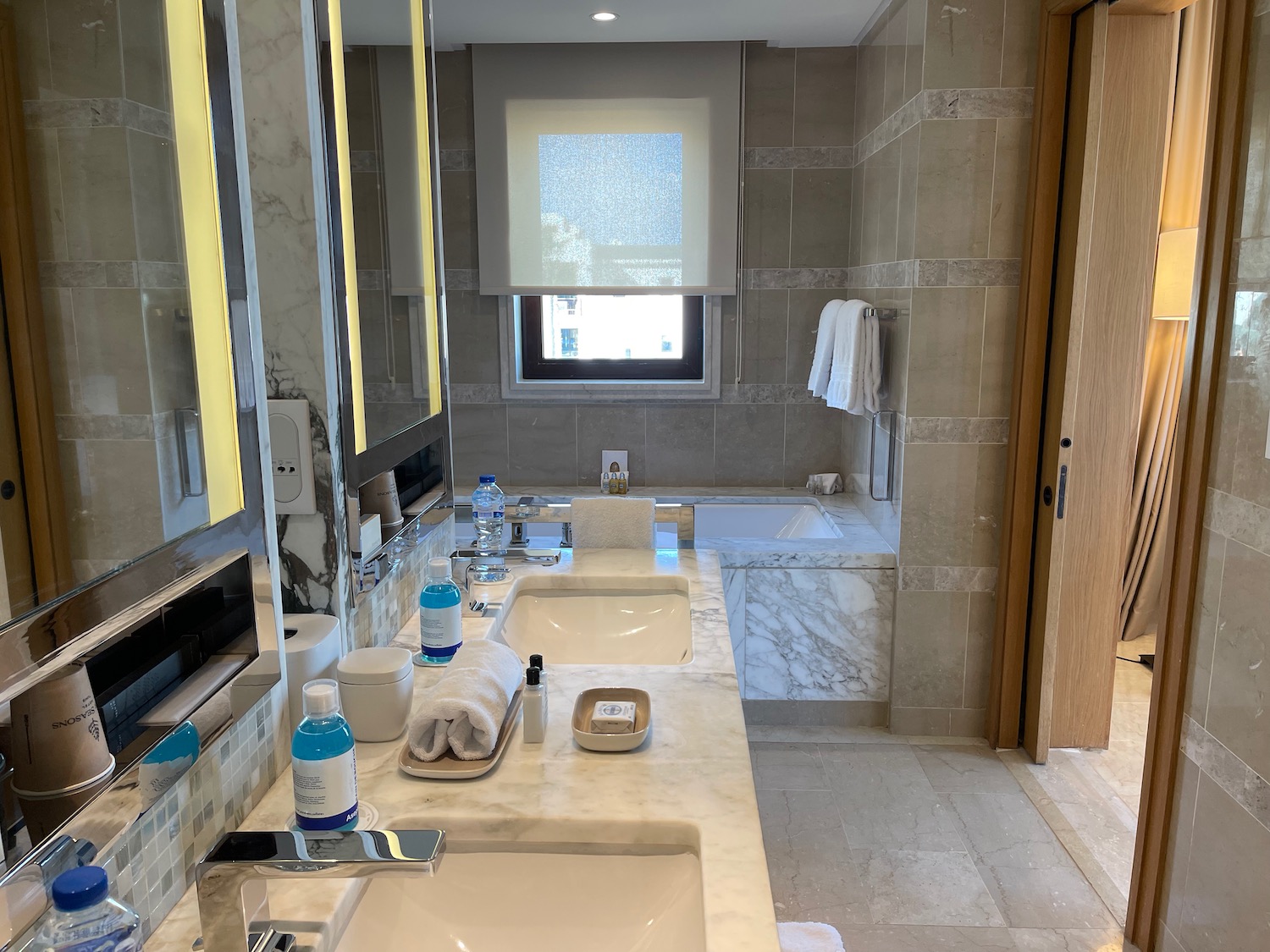 a bathroom with marble counter tops and a tub