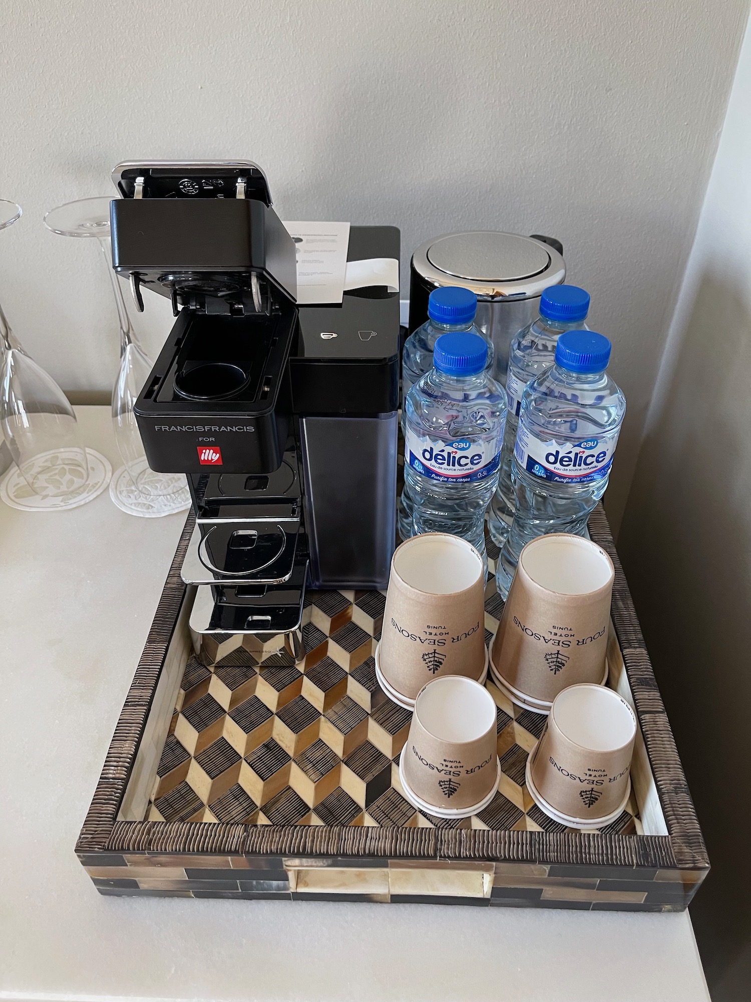 a coffee machine and cups on a tray