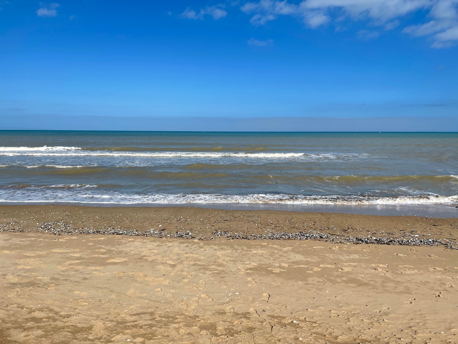 a beach with waves crashing on the shore