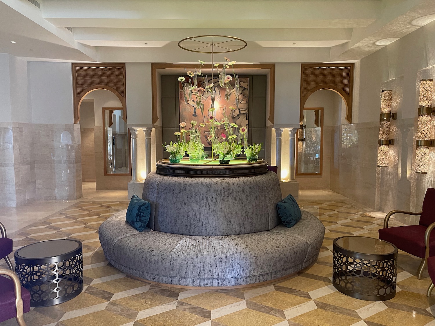 a round table with a chandelier in the middle of a room