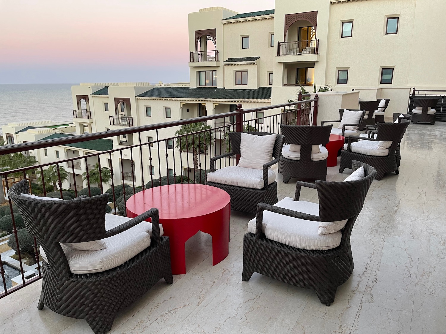 a group of chairs and a table on a balcony