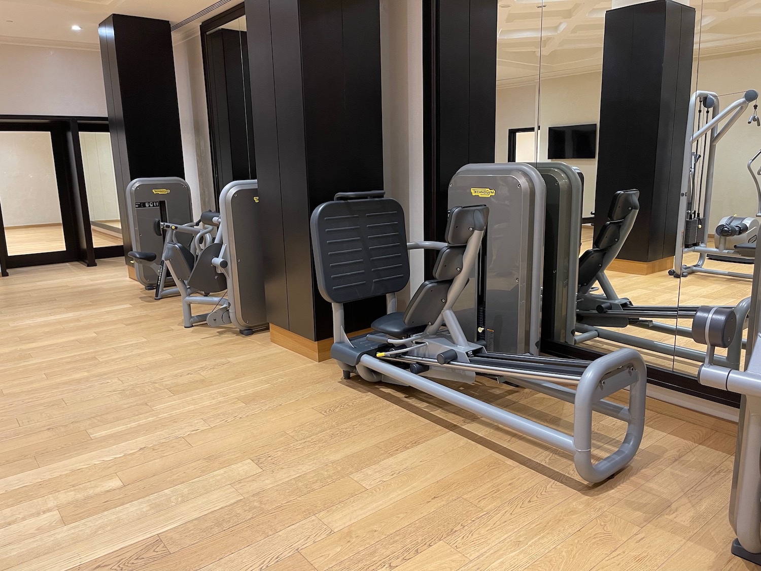 a row of exercise machines in a gym