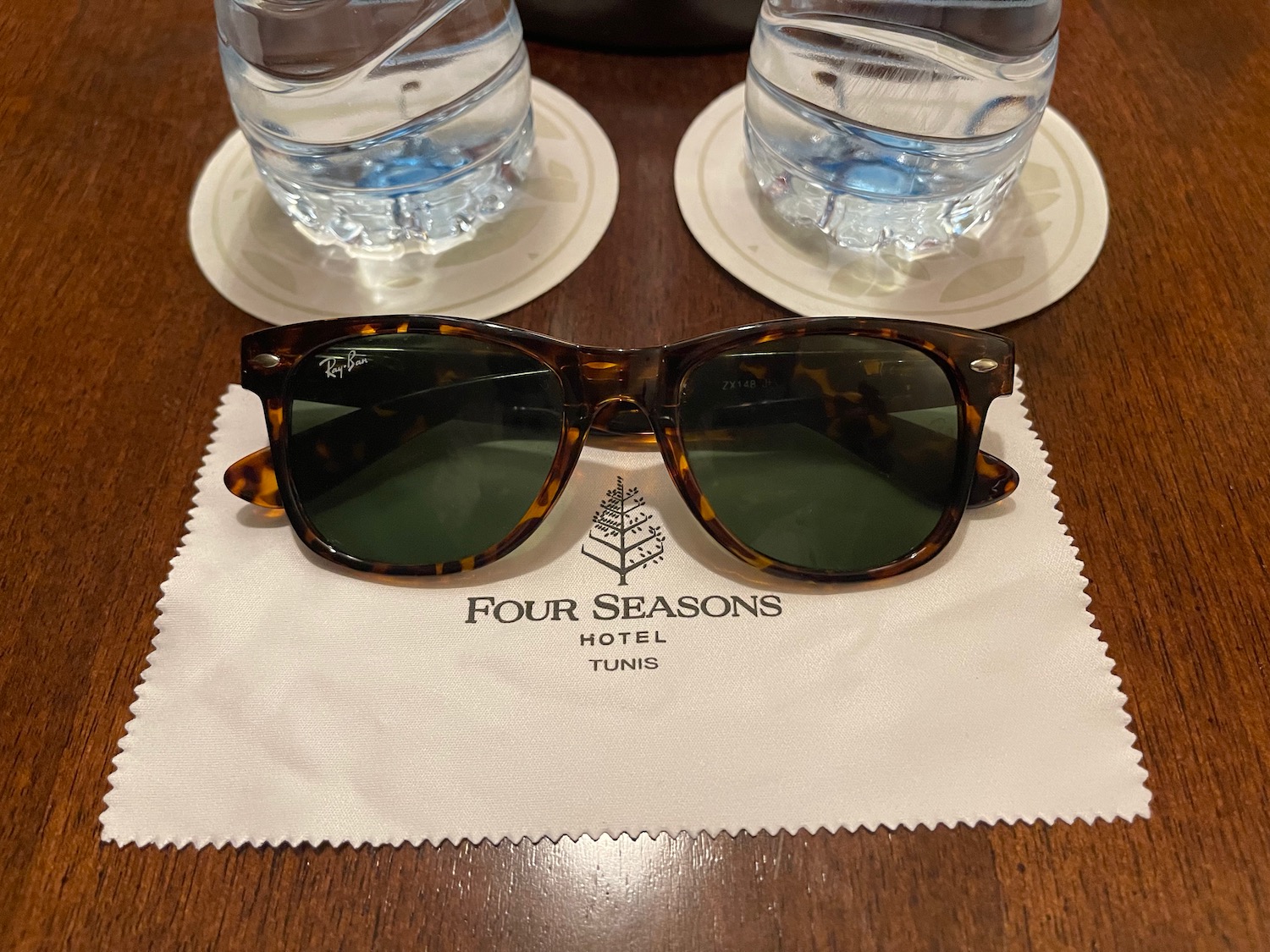 sunglasses on a napkin next to water bottles