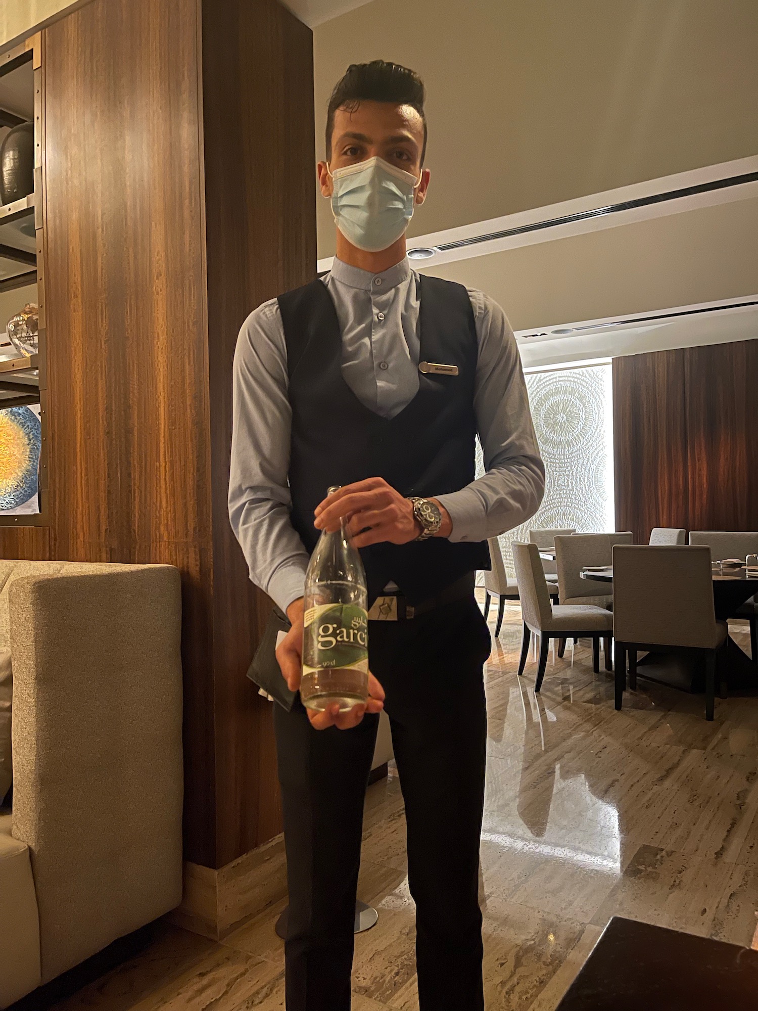 a man wearing a mask and holding a bottle