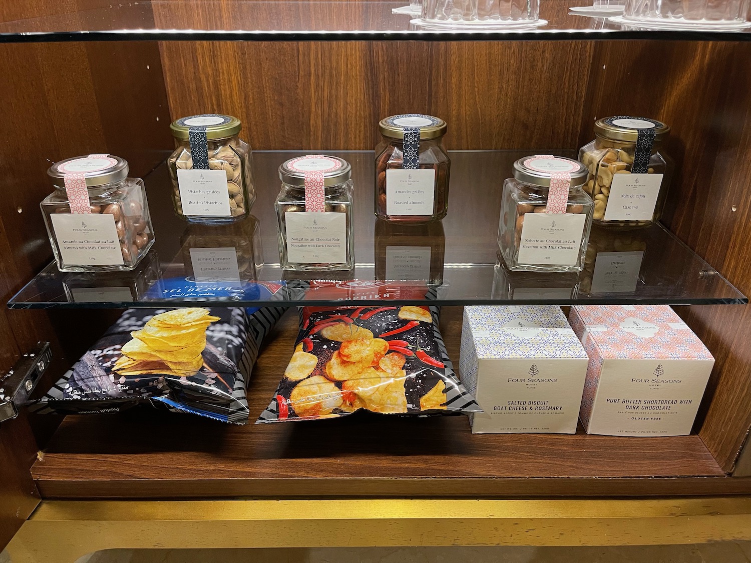 a glass shelf with food and snacks