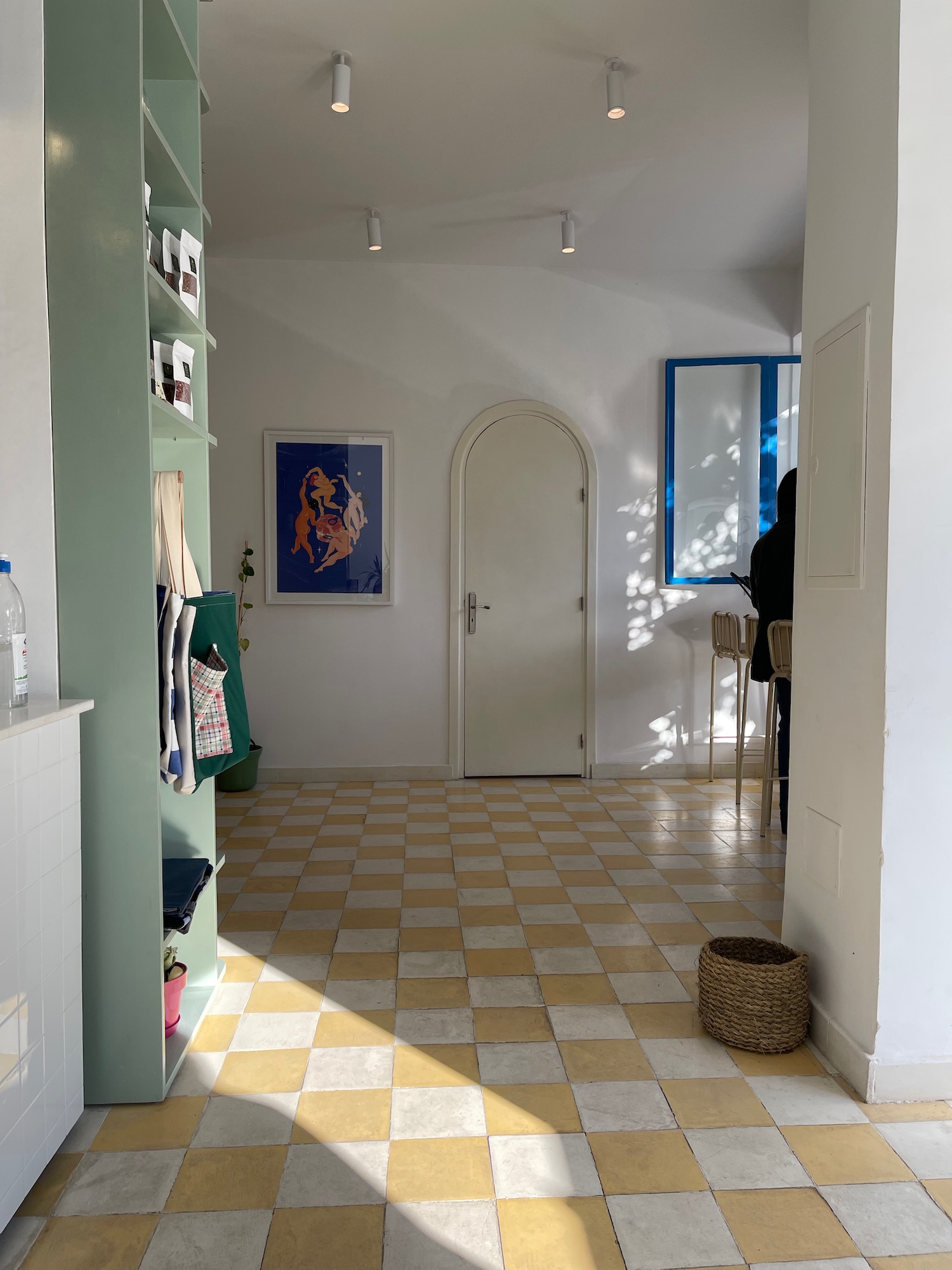 a room with a white door and a checkered floor
