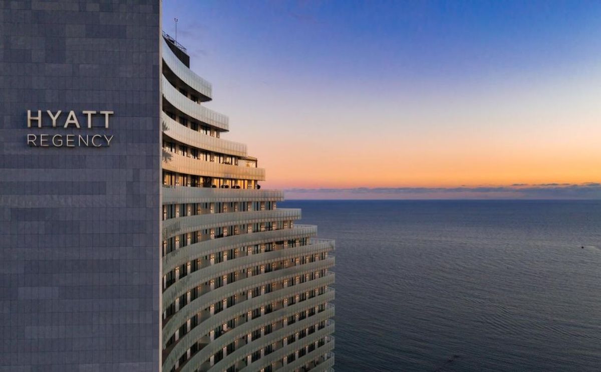 a building with a body of water in the background