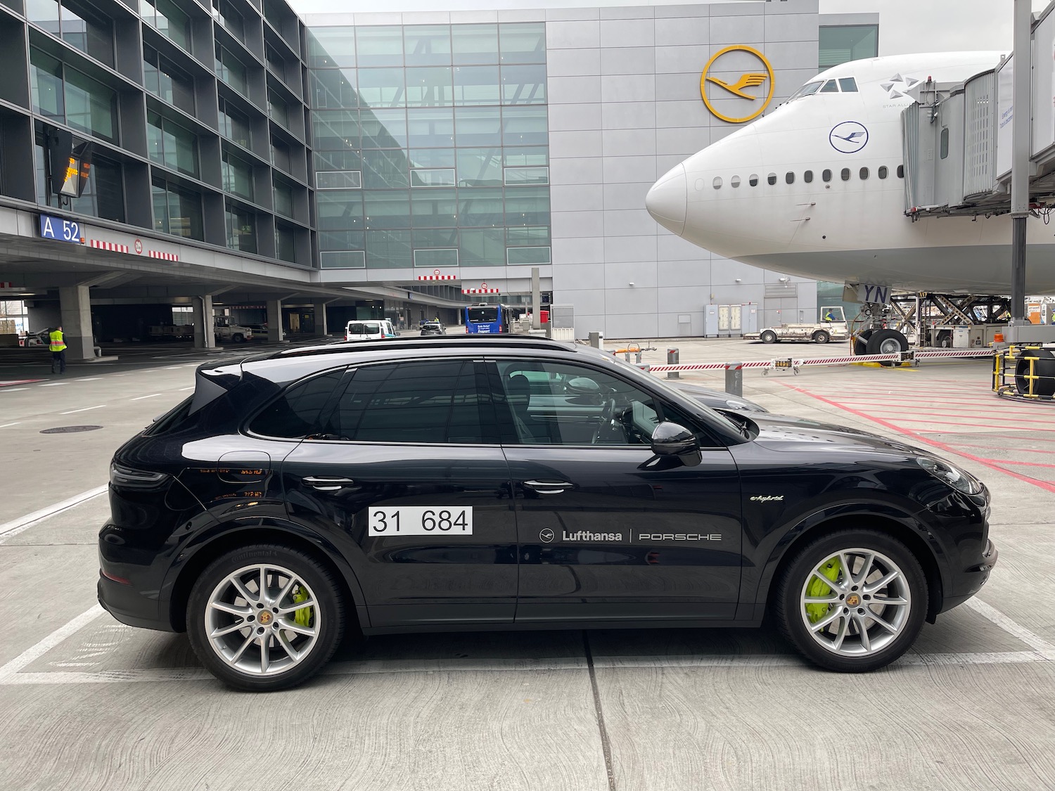 a black car parked in front of a plane