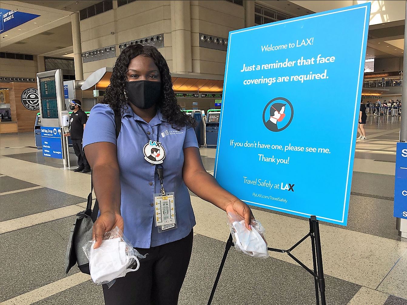 a woman wearing a face mask and holding a sign