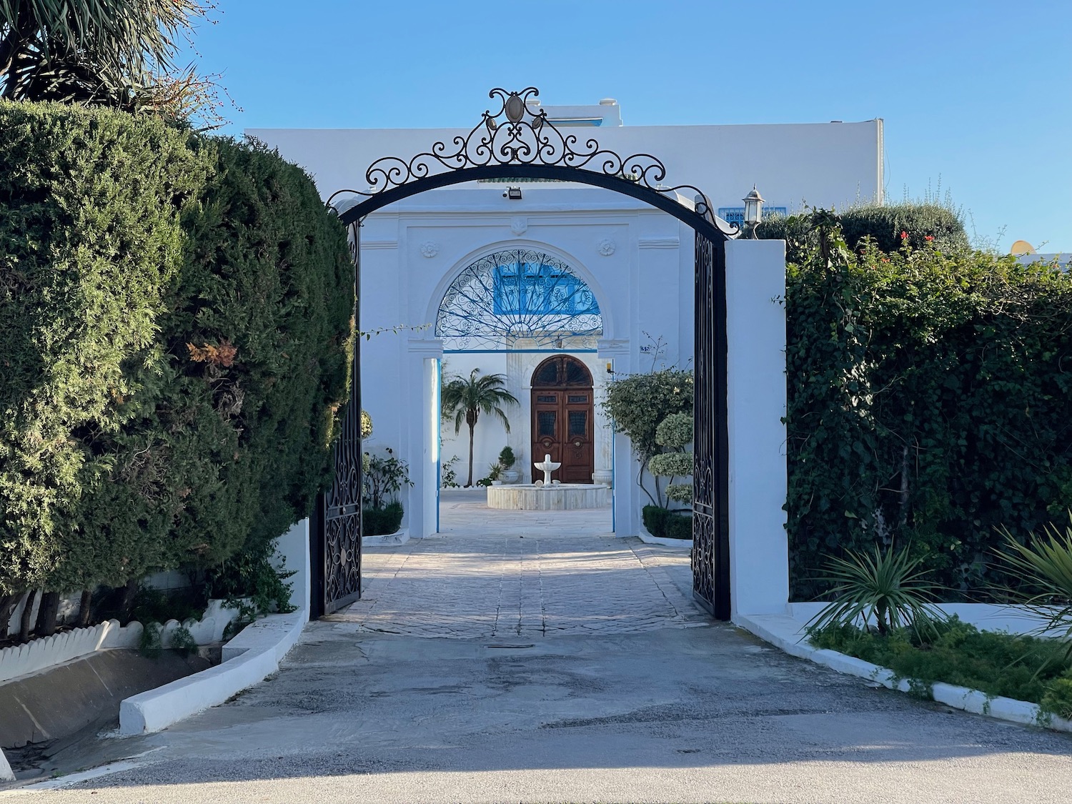 a gated entrance to a white building