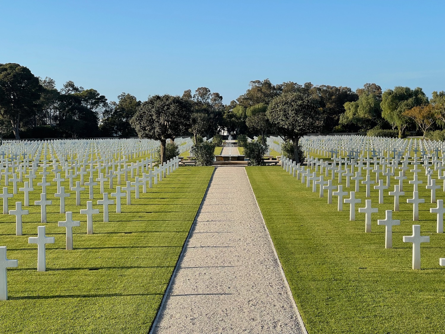 a long walkway leading to a cemetery