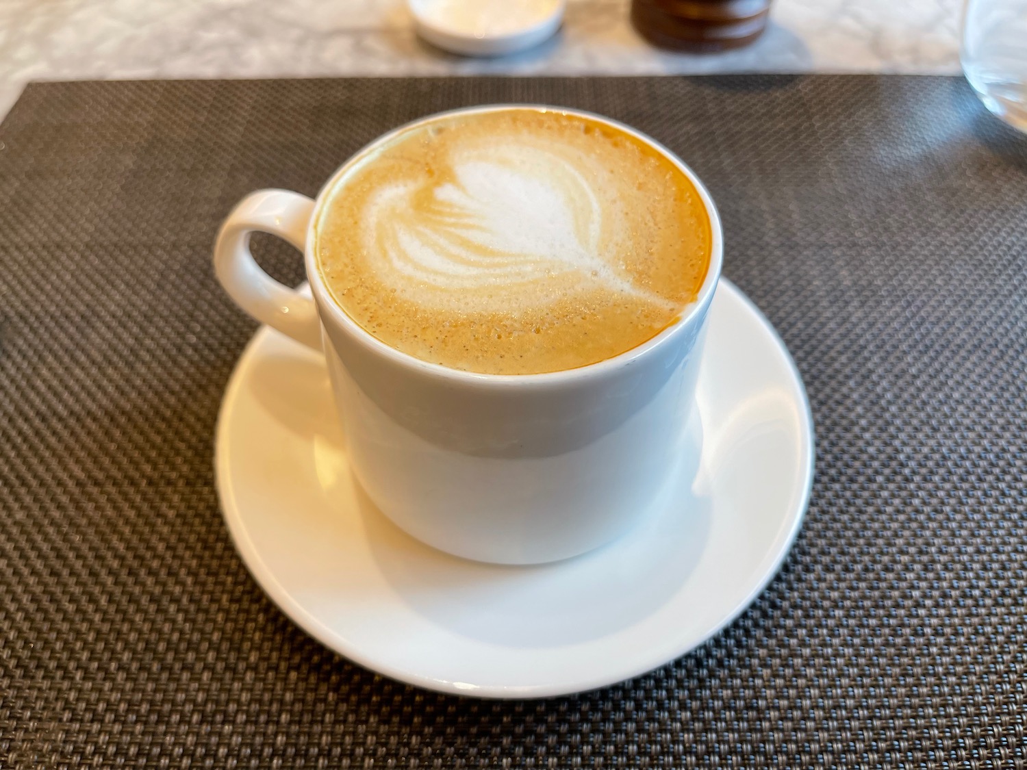 a cup of coffee with a heart shaped foam