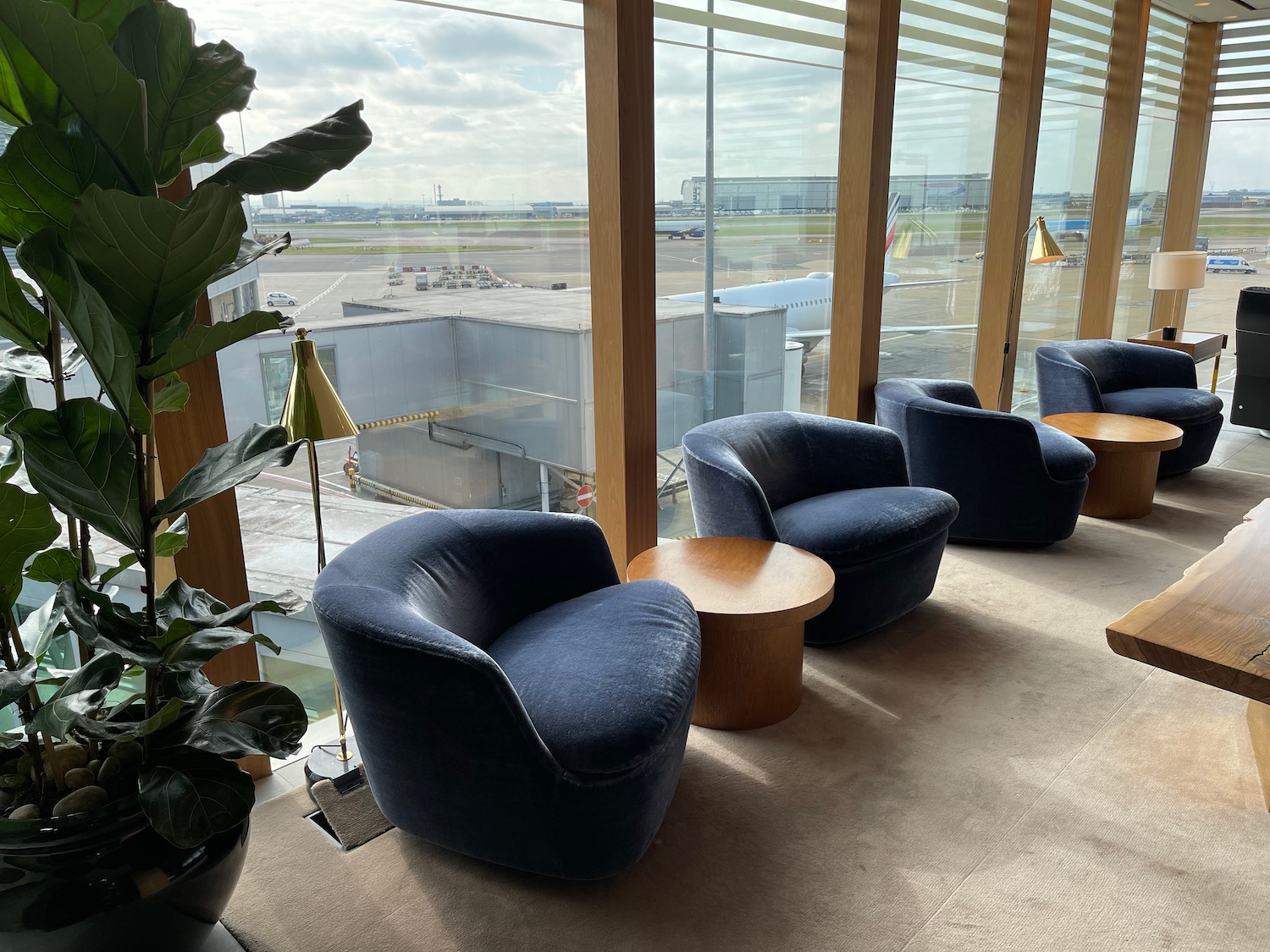 a room with chairs and tables and plants