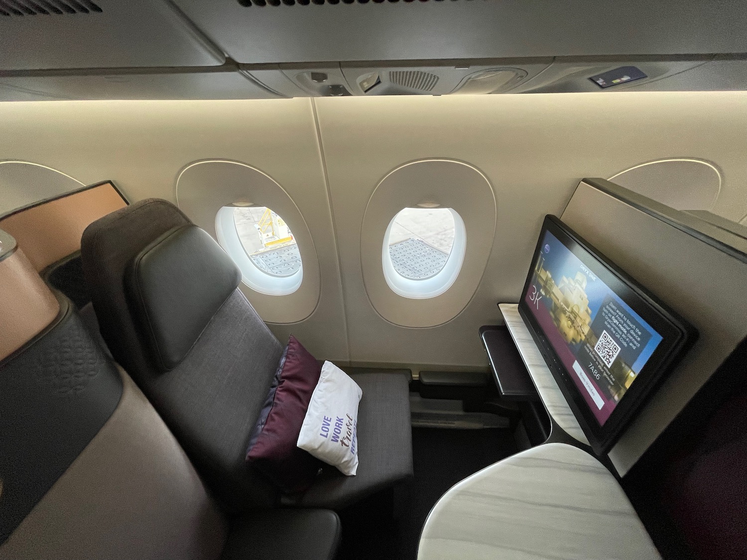 a seat with a monitor and a television on the side of the plane