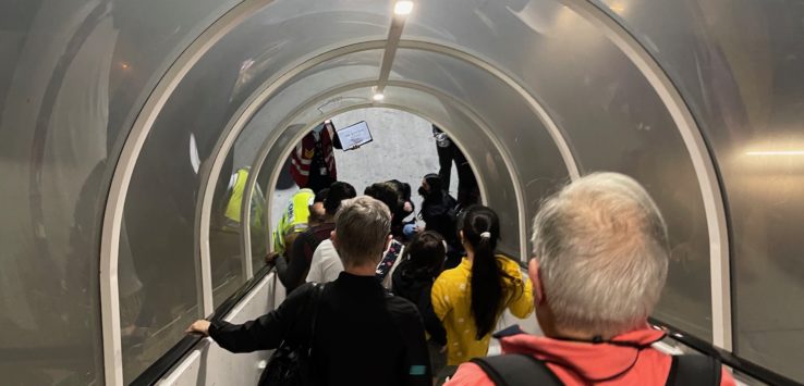 a group of people walking down a tunnel