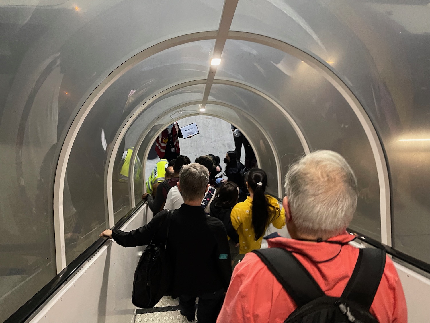 a group of people walking down a tunnel