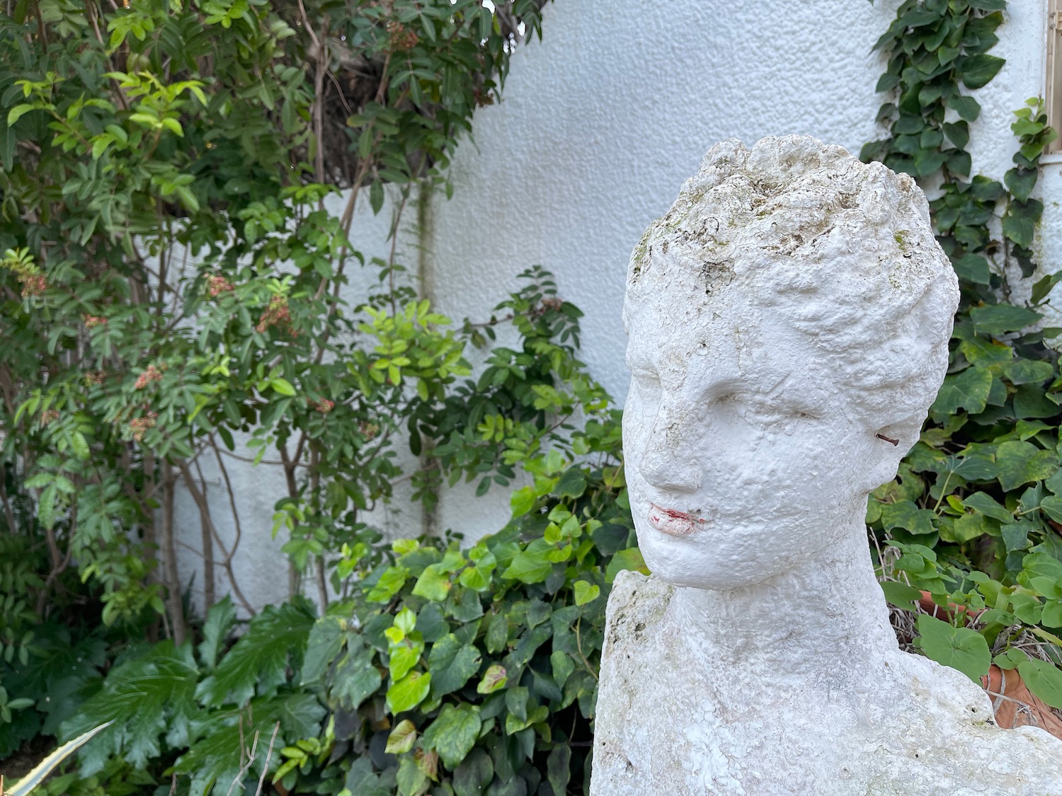 a statue of a woman in a garden