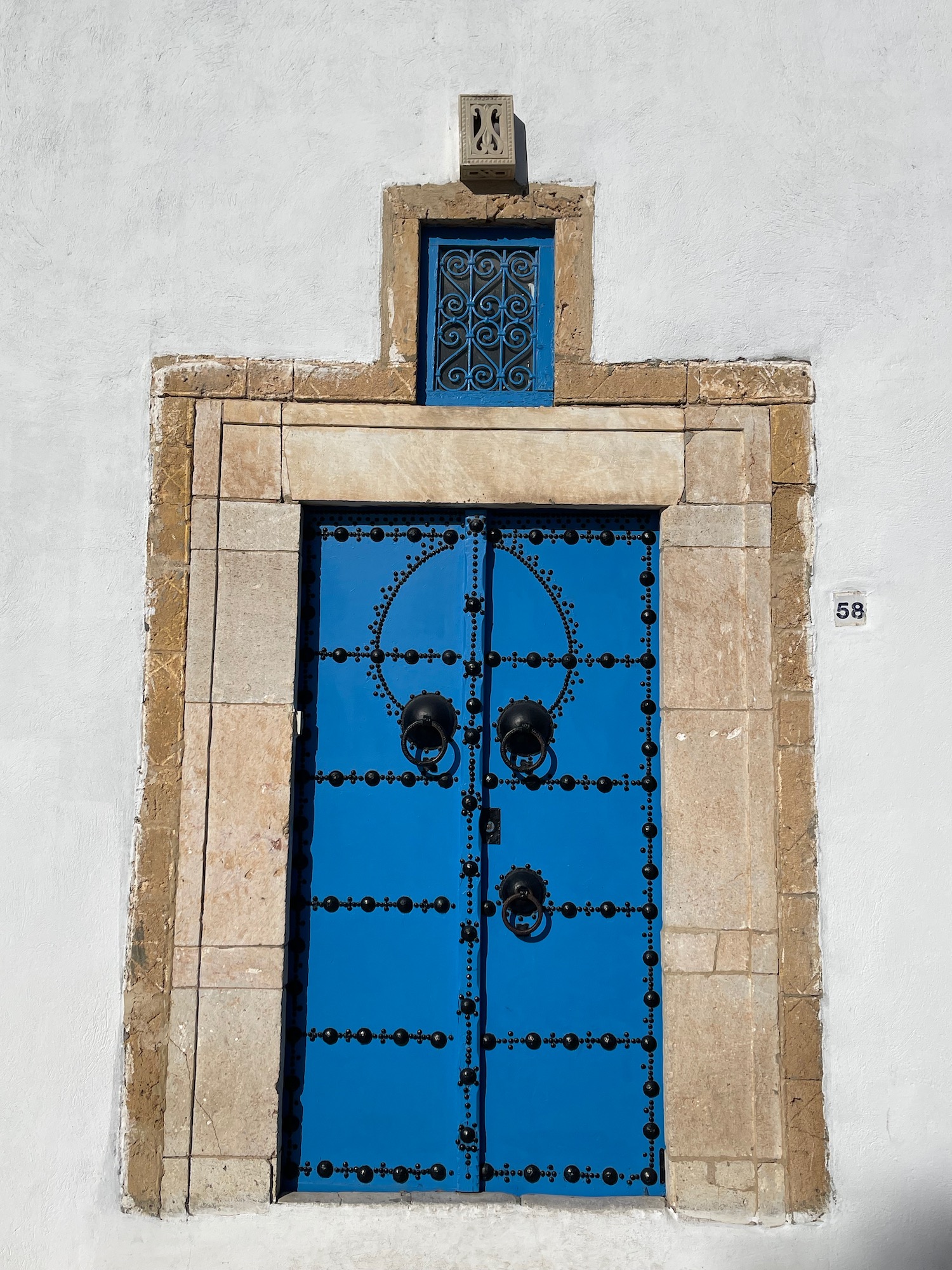 a blue door with black handles