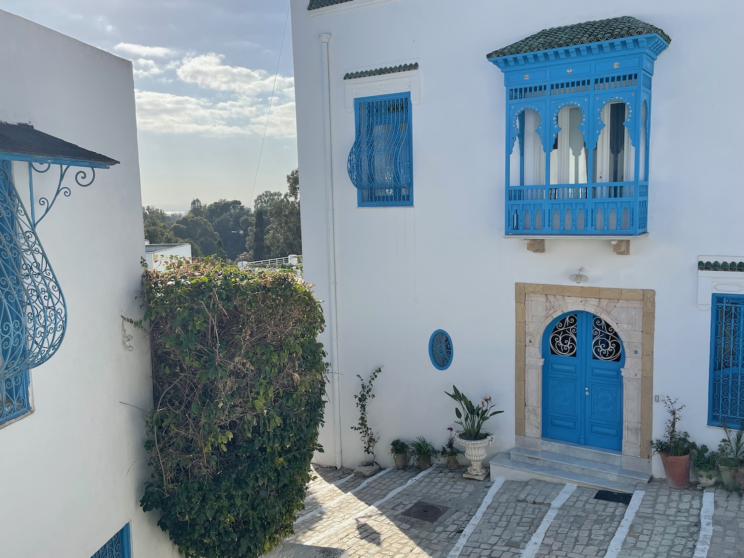 a white building with blue doors and a blue door