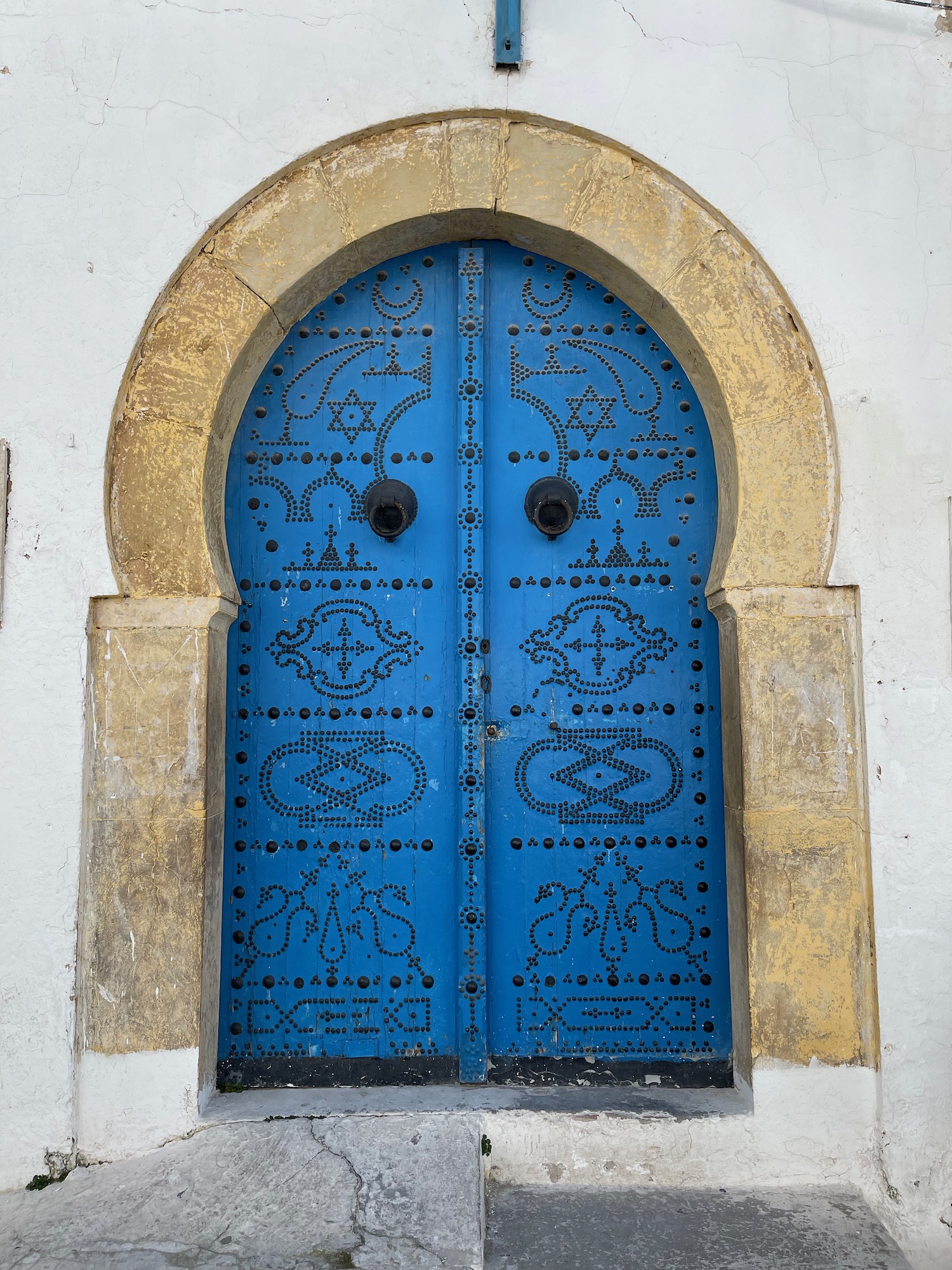 a blue door with a gold arch