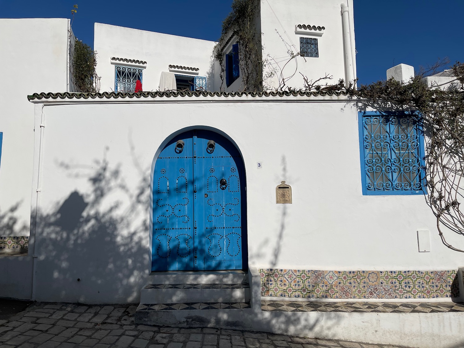 a white building with blue doors and windows