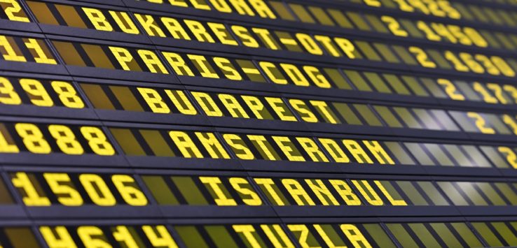 a close-up of a flight information board