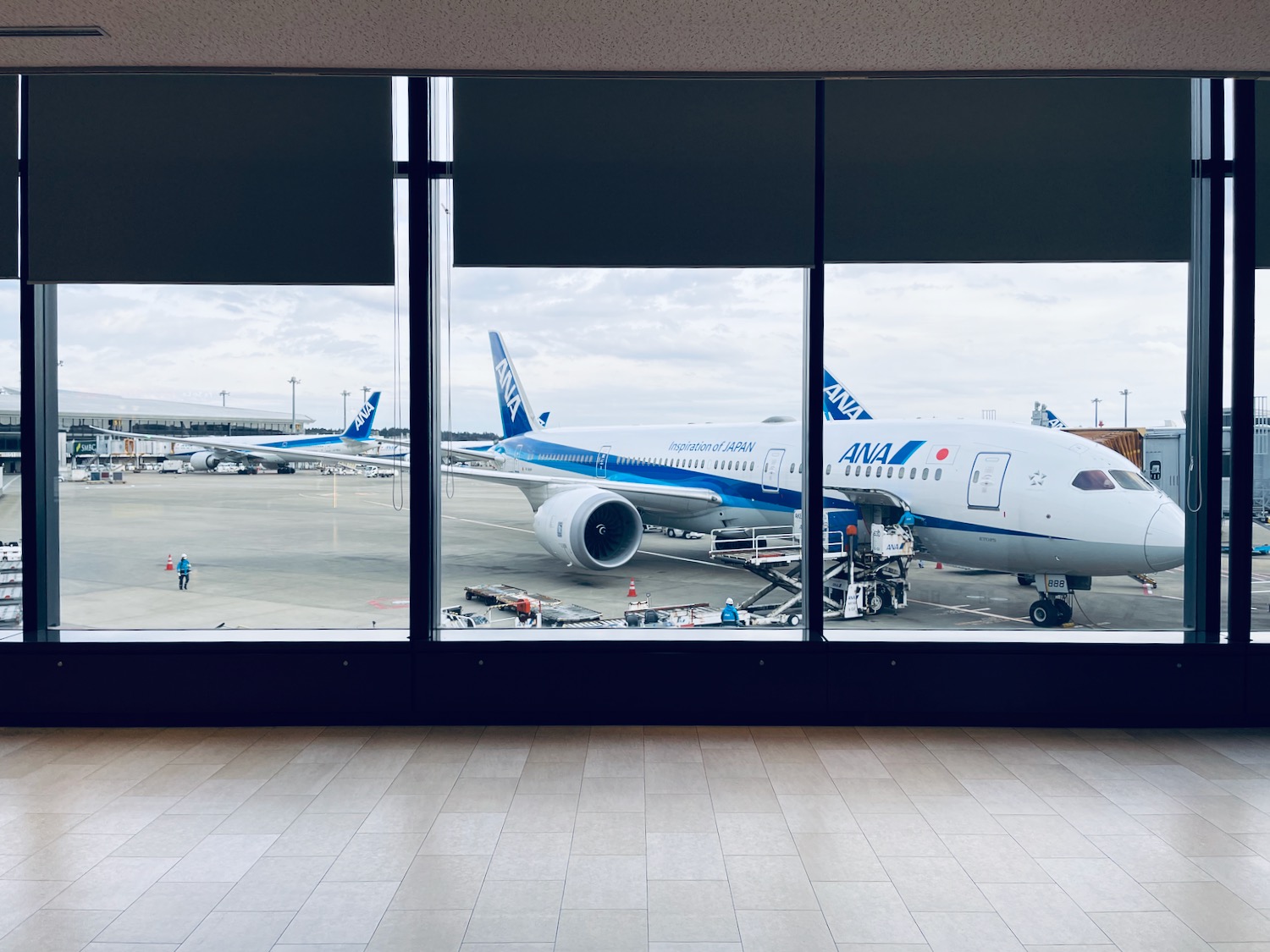 a large window with a plane parked on the tarmac