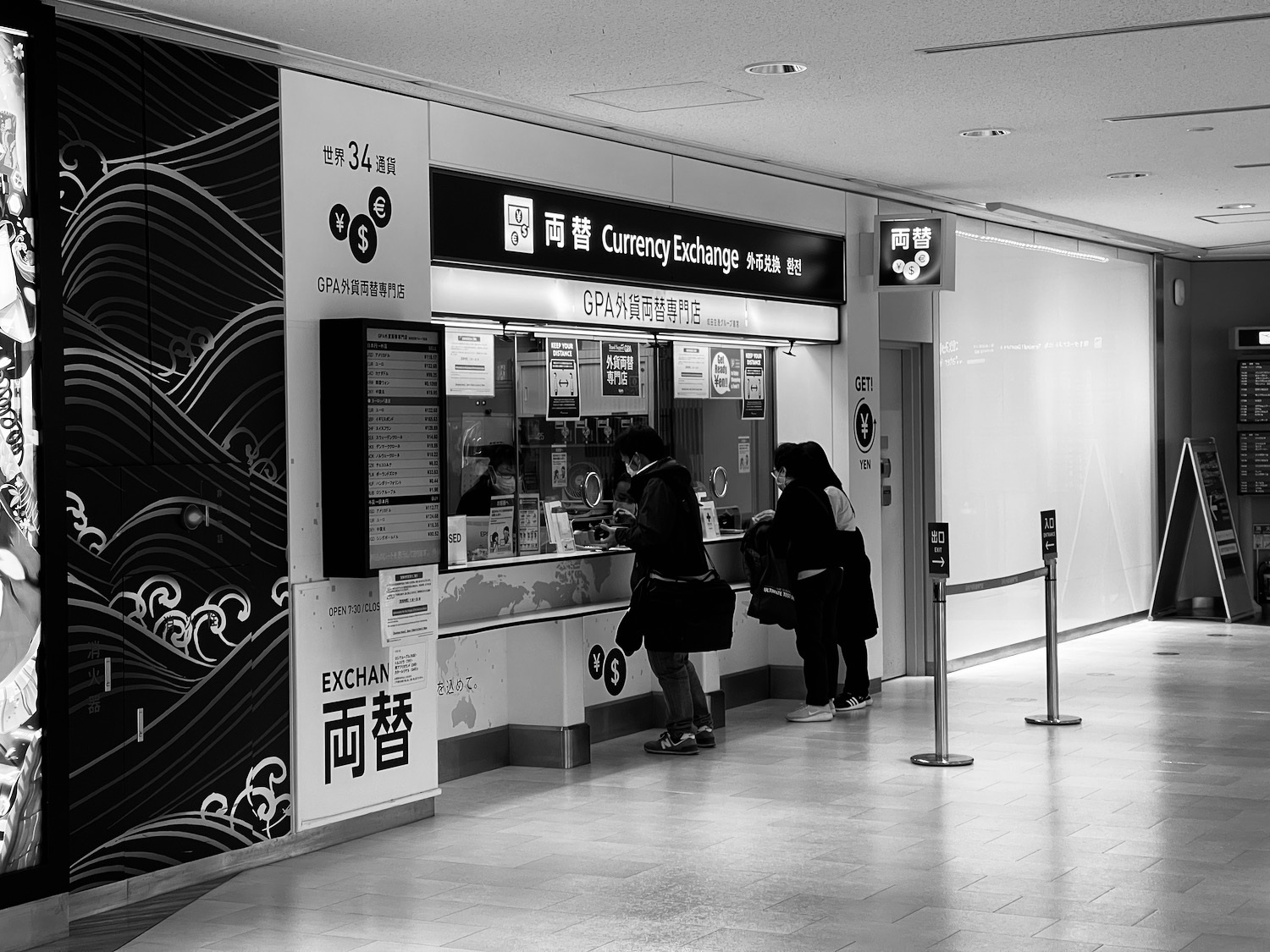 people standing in front of a currency exchange