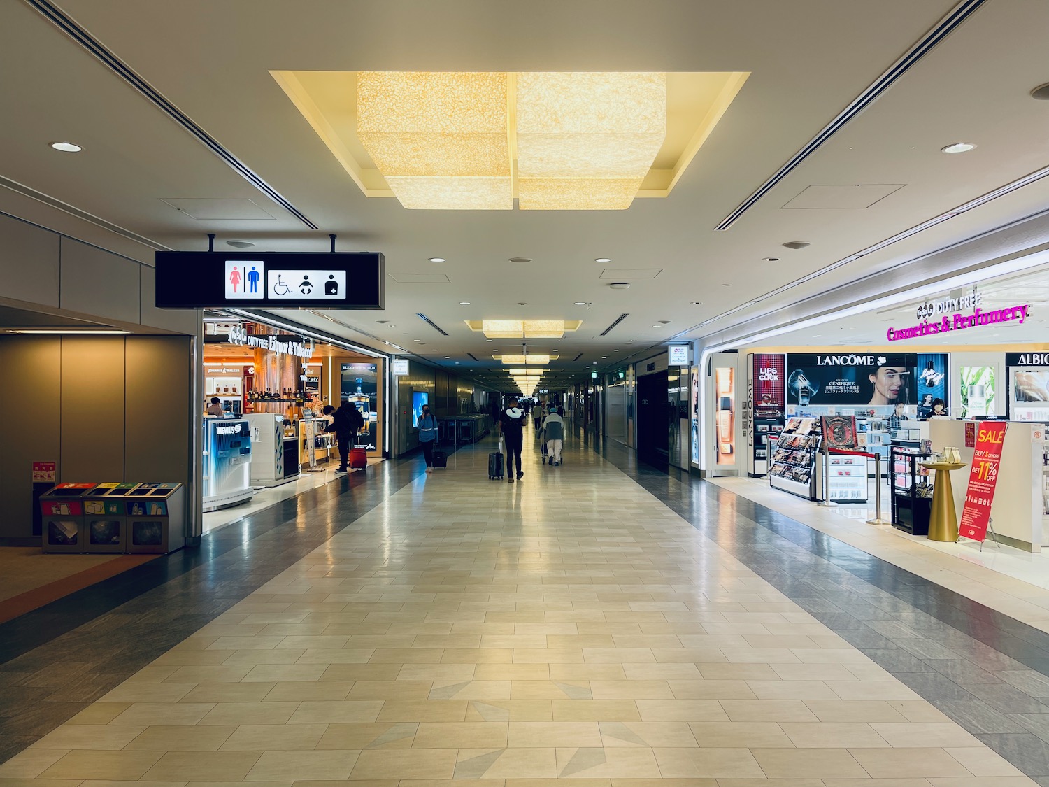 a large hallway with people walking in it