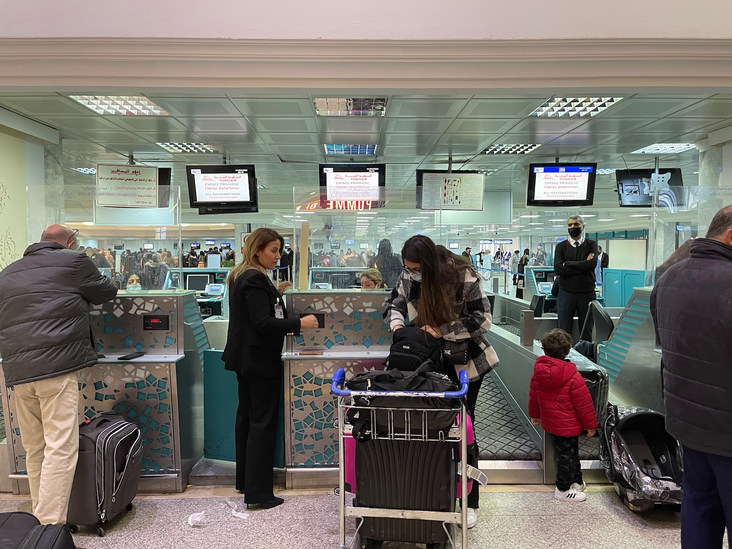 people standing in front of a check-in counter