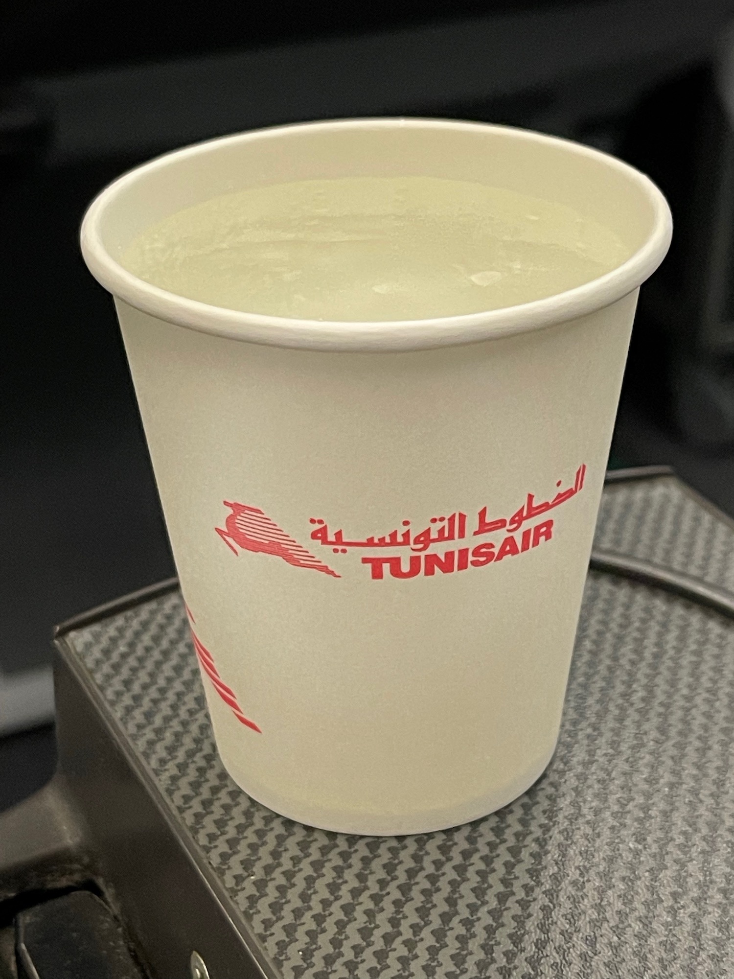 a white cup with liquid in it