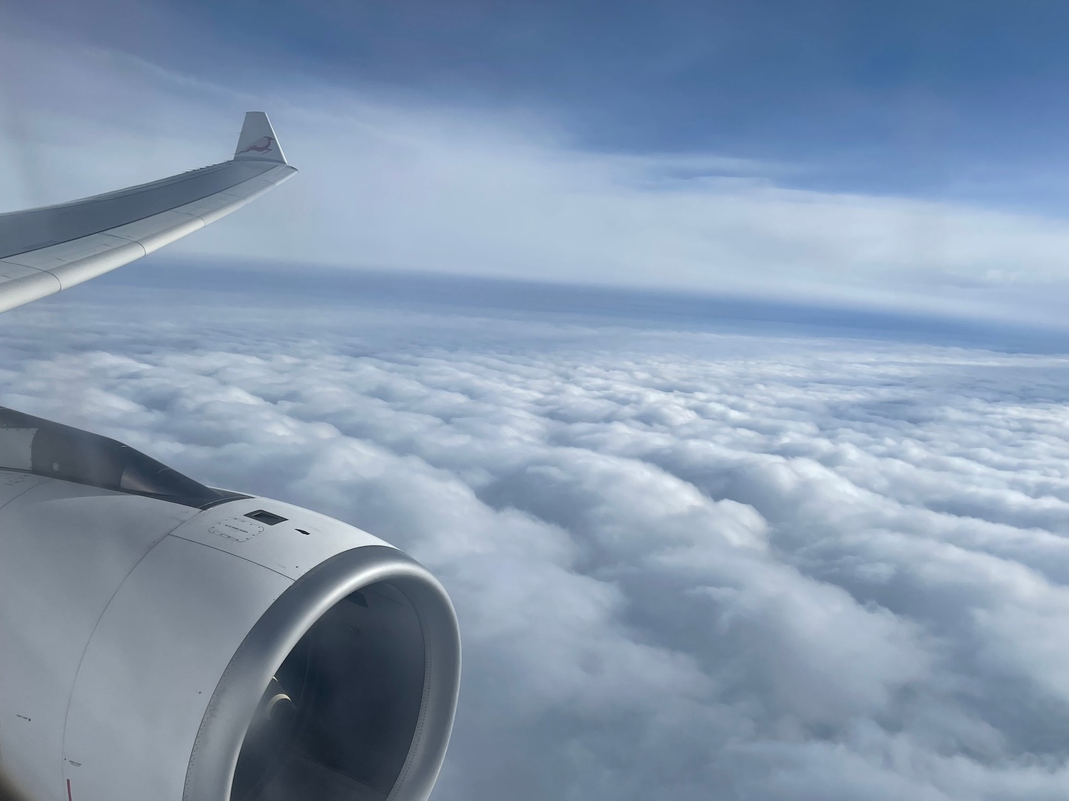 an airplane wing and clouds