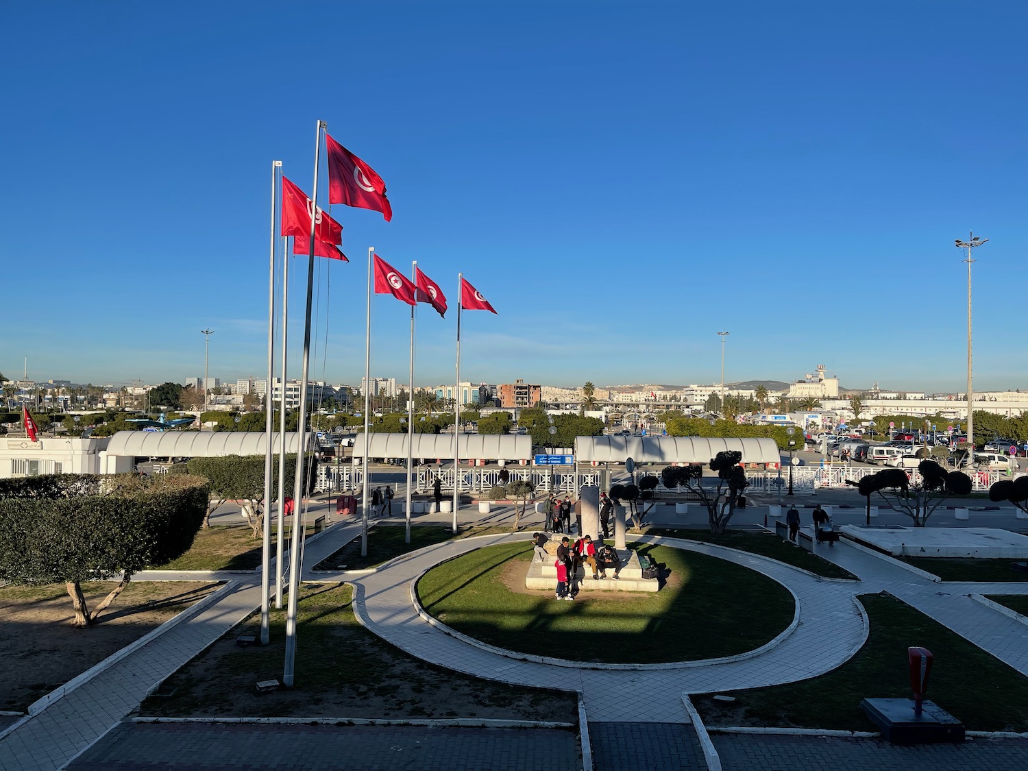 flags on poles with people walking around