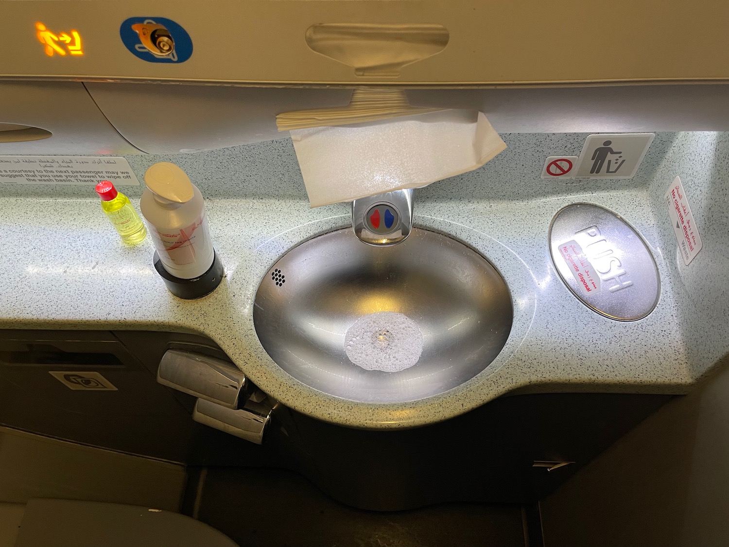 a sink with a paper towel and soap on it