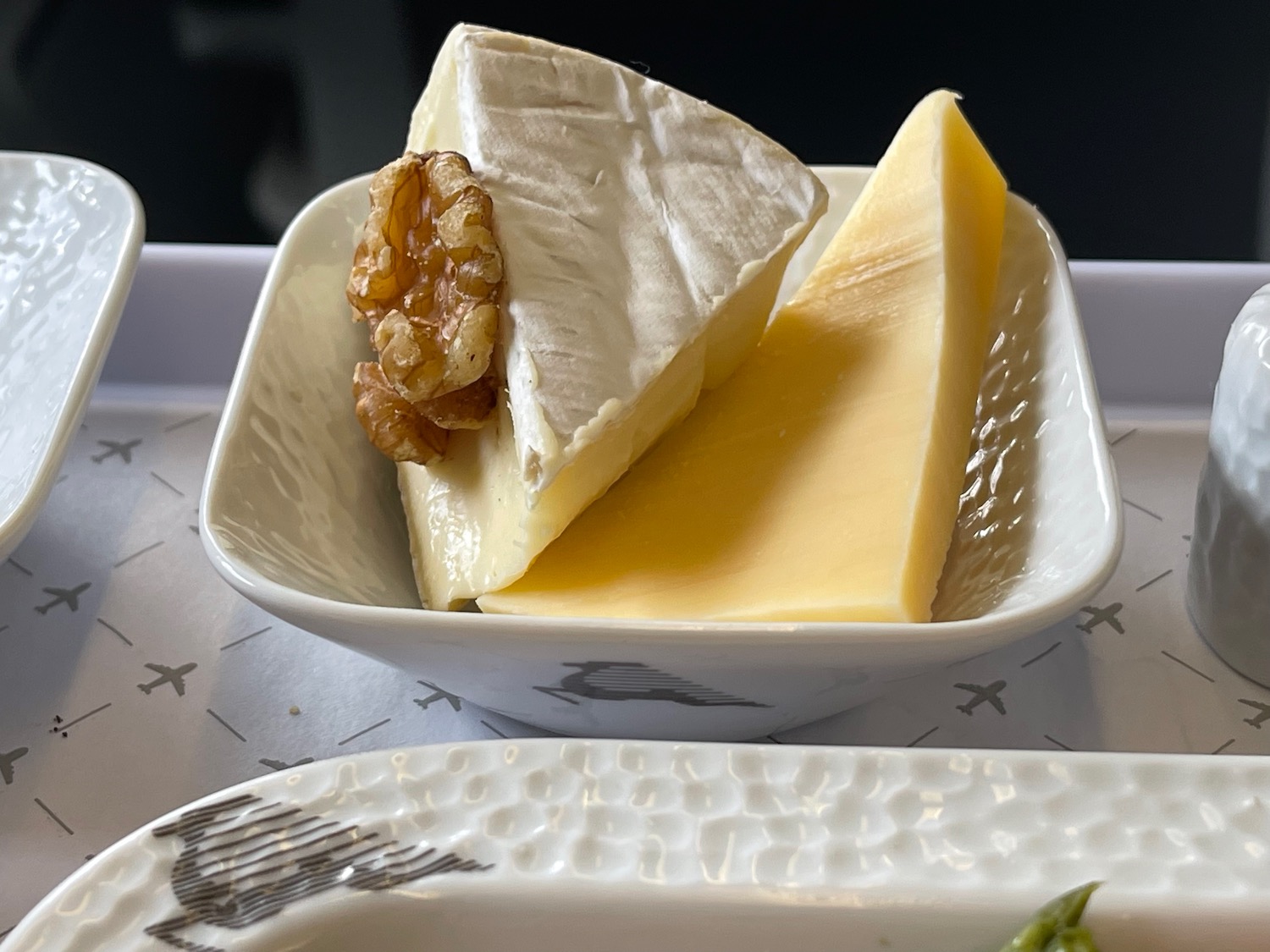 a bowl of cheese and walnuts