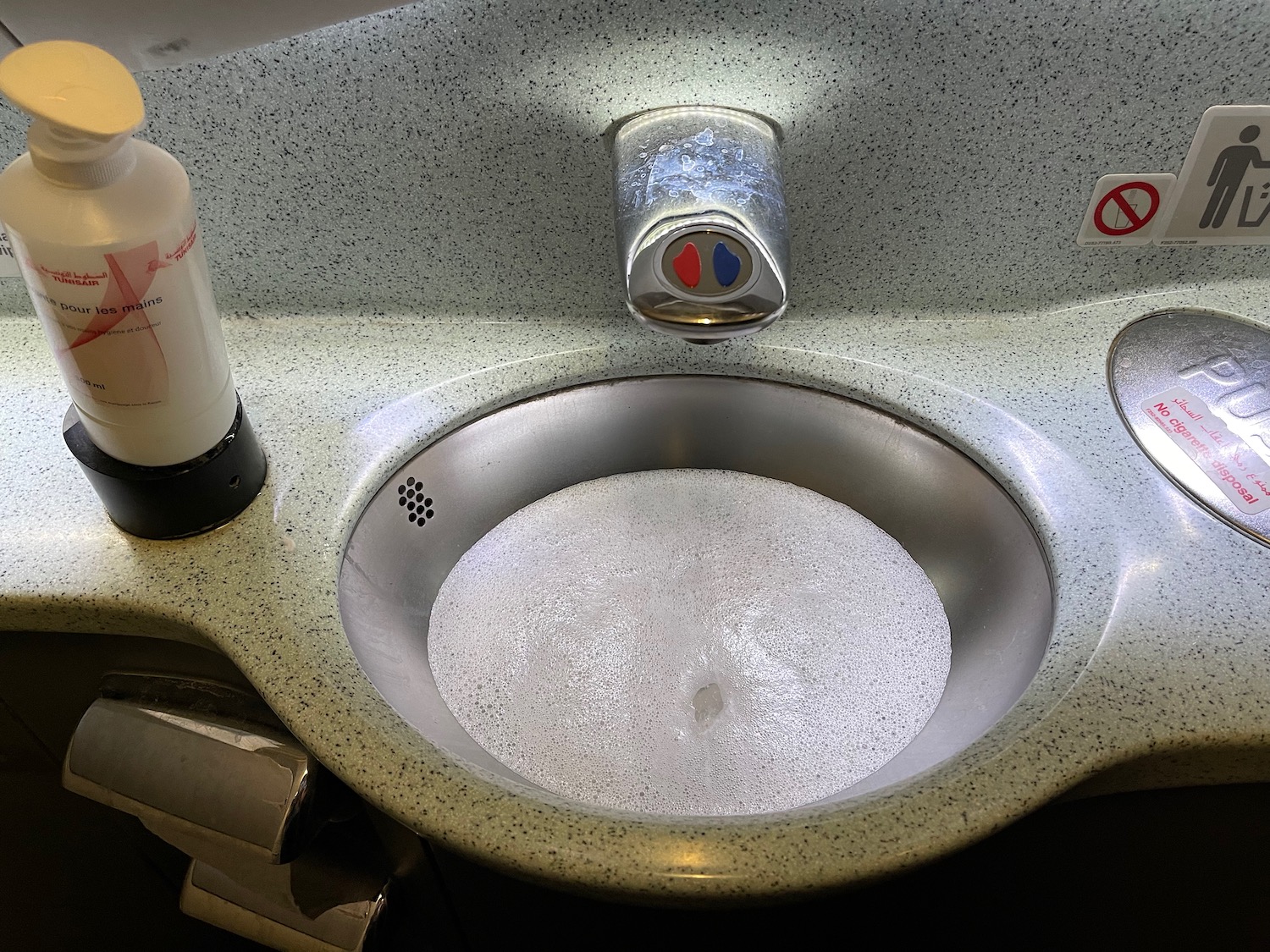 a sink with soap and soap dispenser