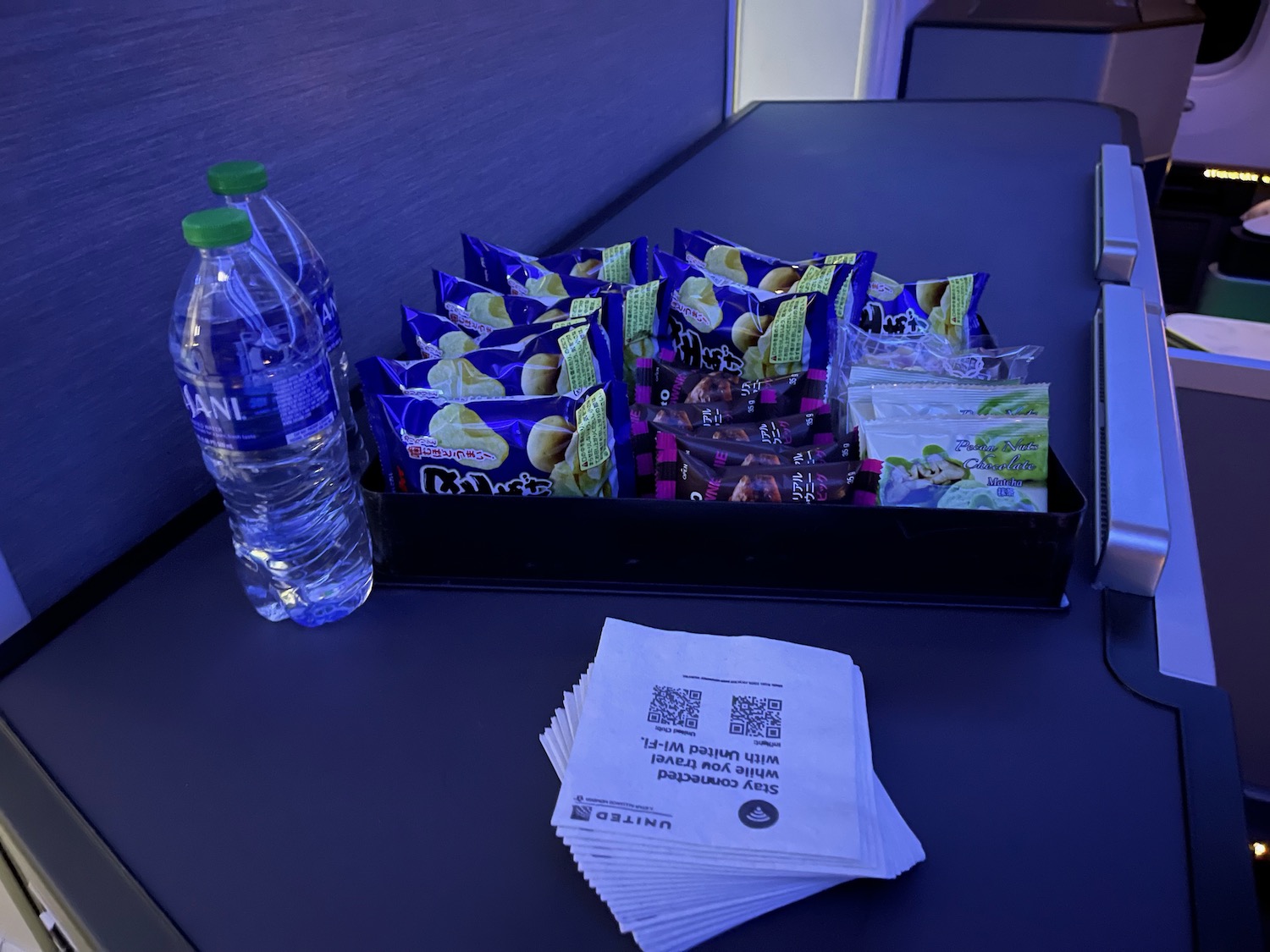 a group of packages and a bottle of water on a table