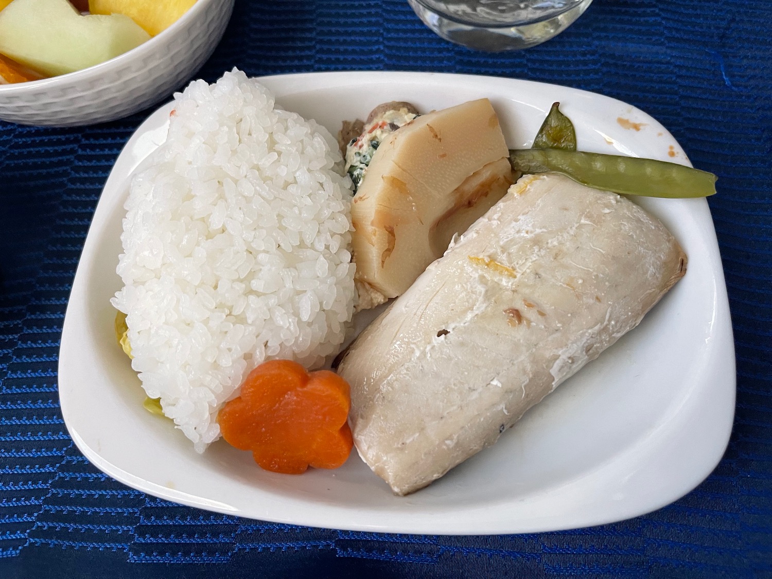 a plate of food on a blue place mat