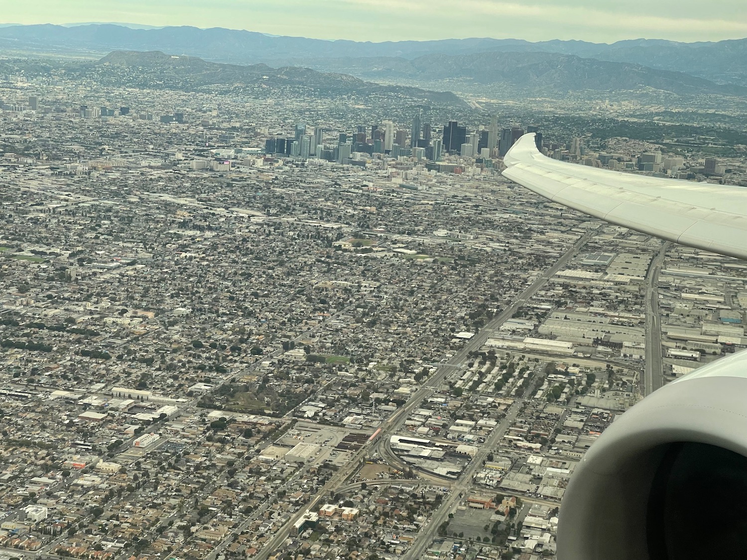 an airplane wing over a city