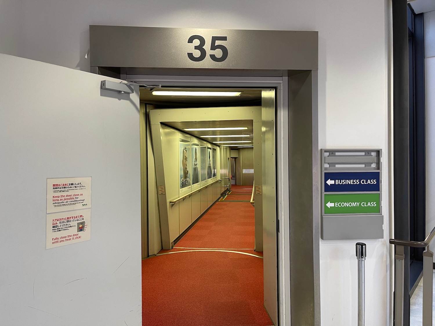 an elevator with a red carpet and a sign